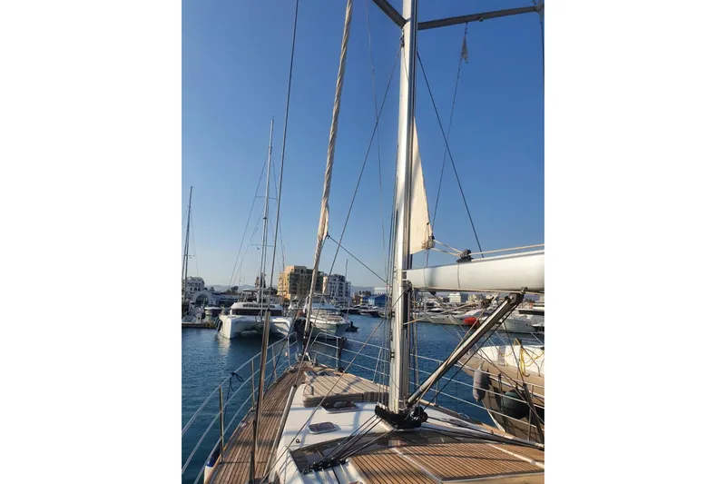  Yacht Photos Pics Sailboat Jeanneau 57, 2013 model, docked in a marina under clear blue skies.