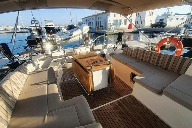  Yacht Photos Pics Spacious deck of a 2013 Jeanneau 57 yacht docked at a marina.
