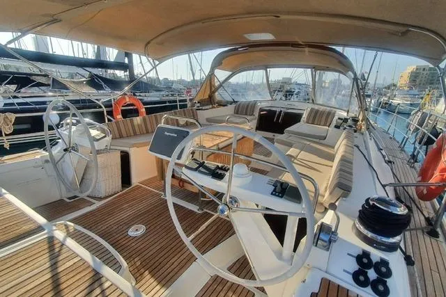  Yacht Photos Pics 2013 Jeanneau 57 yacht with dual steering wheels and spacious deck in marina.