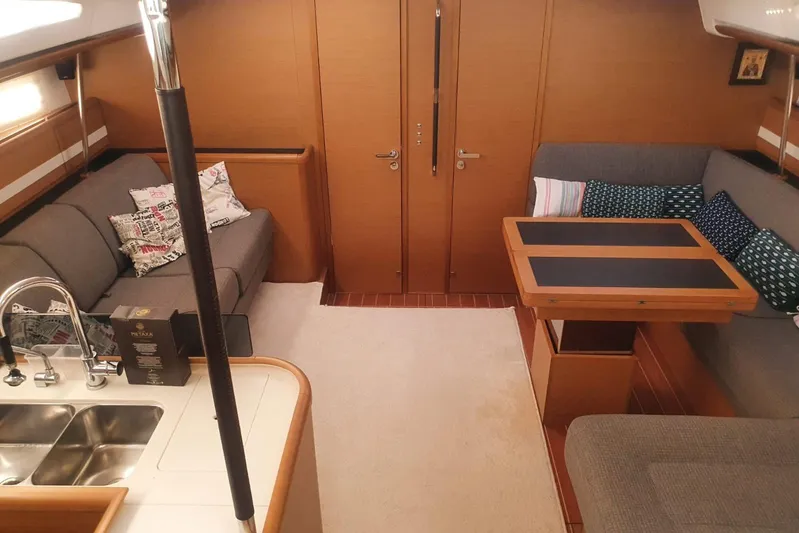  Yacht Photos Pics Luxurious interior of 2013 Jeanneau 57 yacht with cozy seating and modern kitchen area.