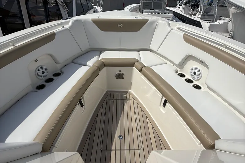  Yacht Photos Pics 2016 Sailfish 325 DC boat interior with cushioned seating and cup holders.