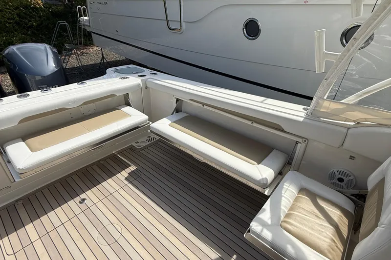  Yacht Photos Pics 2016 Sailfish 325 DC boat interior with cushioned seating and teak flooring.