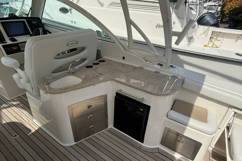  Yacht Photos Pics 2016 Sailfish 325 DC boat interior with sink, storage, and seating area.