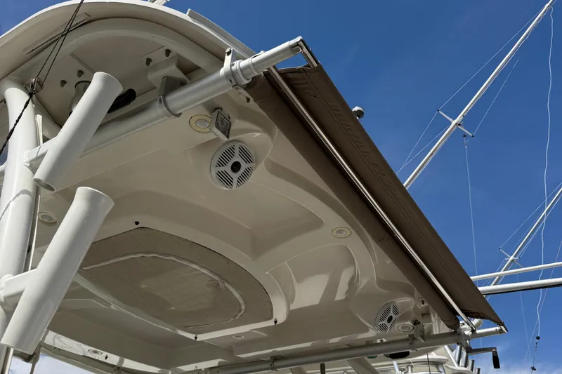  Yacht Photos Pics 2016 Sailfish 325 DC boat canopy and speakers under clear blue sky.