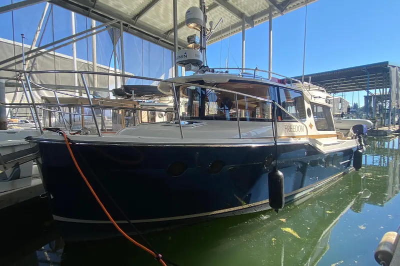  Yacht Photos Pics 2019 Ranger Tugs R-29 S boat docked under a covered marina.