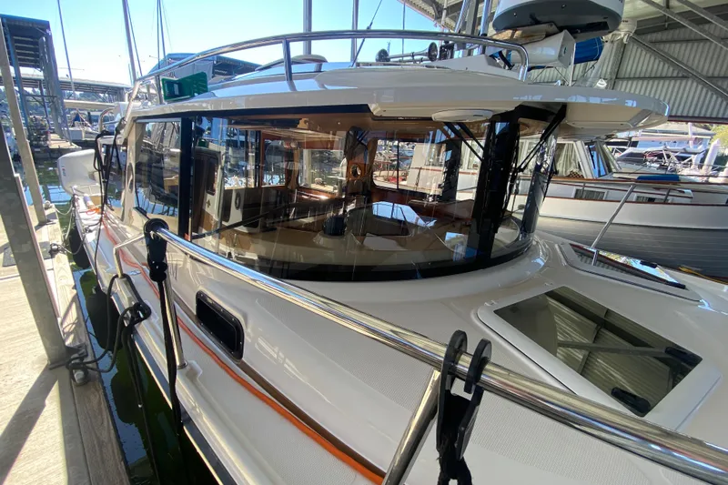  Yacht Photos Pics 2019 Ranger Tugs R-29 S docked in a marina, showcasing sleek design and spacious interior.
