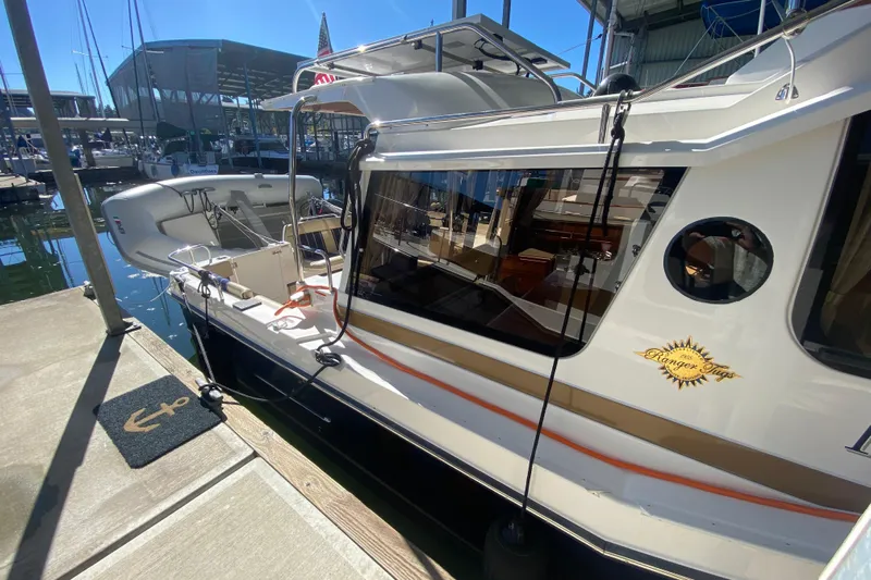  Yacht Photos Pics 2019 Ranger Tugs R-29 S docked at marina, showcasing sleek design and modern features.