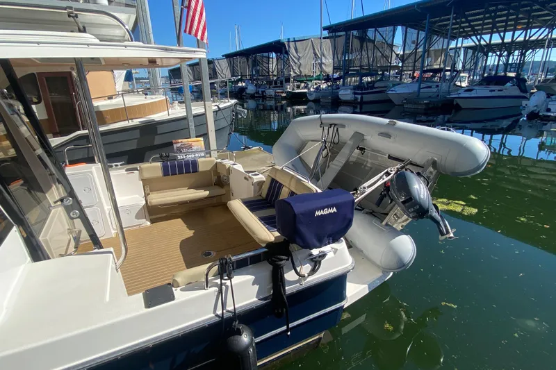  Yacht Photos Pics 2019 Ranger Tugs R-29 S docked with inflatable boat and American flag.