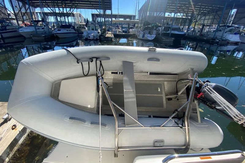 Yacht Photos Pics 2019 Ranger Tugs R-29 S inflatable boat docked at marina, surrounded by other vessels.