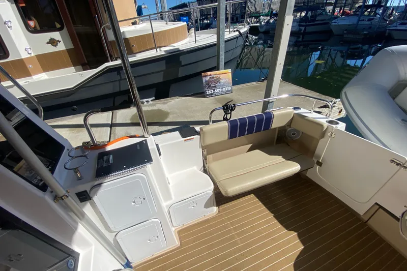  Yacht Photos Pics 2019 Ranger Tugs R-29 S boat interior with seating and dock view.