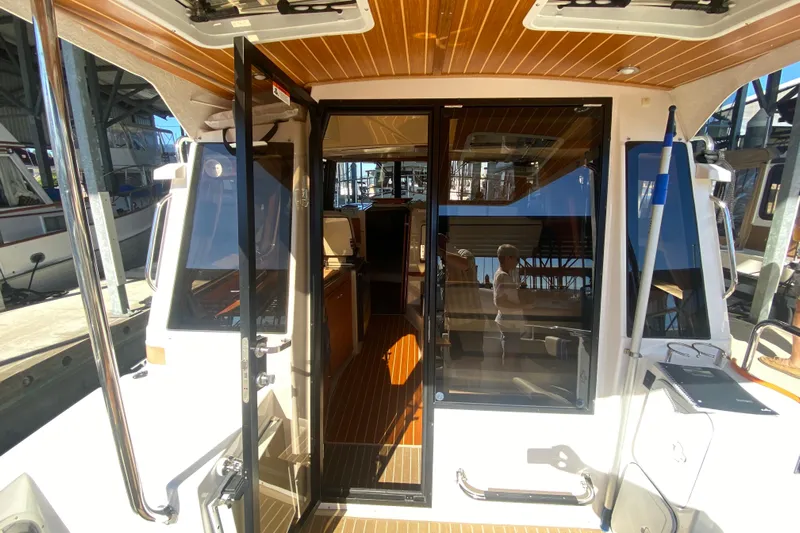  Yacht Photos Pics 2019 Ranger Tugs R-29 S boat interior with open glass doors and wooden flooring.