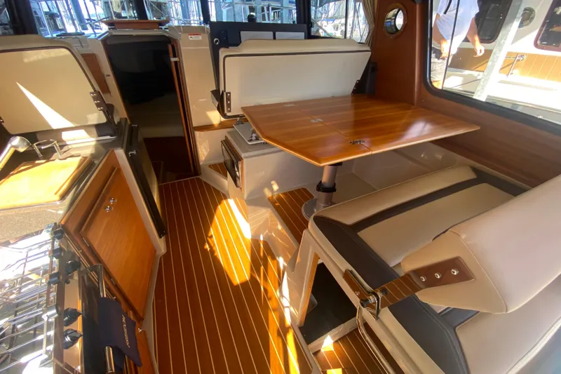  Yacht Photos Pics 2019 Ranger Tugs R-29 S interior with wood accents and dining area.
