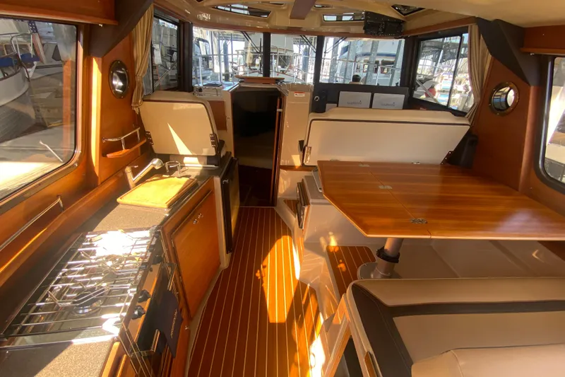  Yacht Photos Pics Interior of 2019 Ranger Tugs R-29 S, featuring a cozy dining and kitchen area.