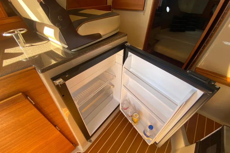  Yacht Photos Pics 2019 Ranger Tugs R-29 S interior with open mini fridge and seating.