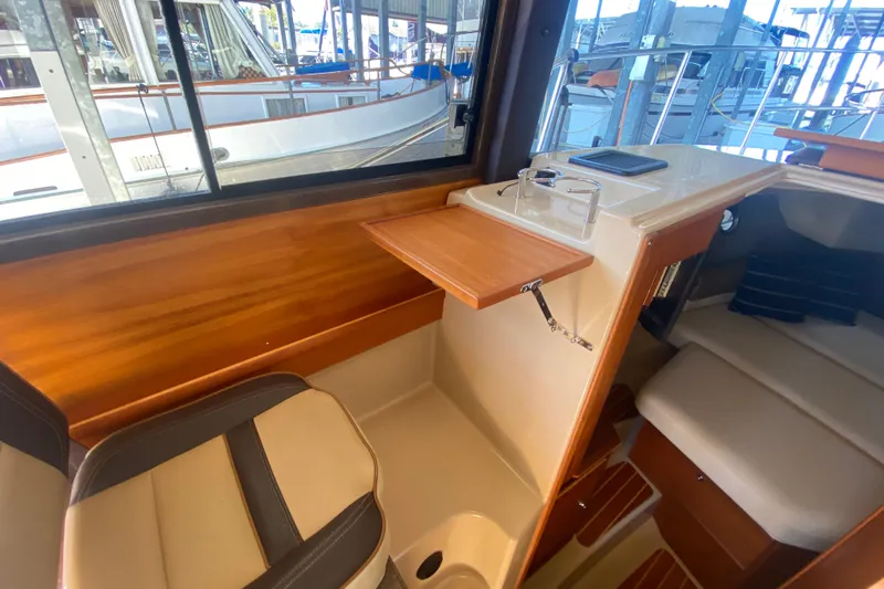  Yacht Photos Pics 2019 Ranger Tugs R-29 S interior with wood accents and seating area.