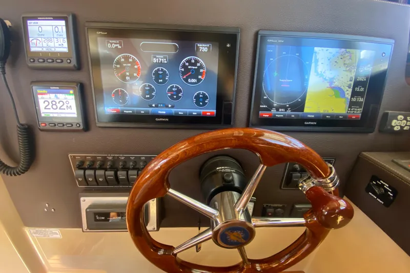  Yacht Photos Pics Dashboard of 2019 Ranger Tugs R-29 S with Garmin navigation displays and wooden steering wheel.