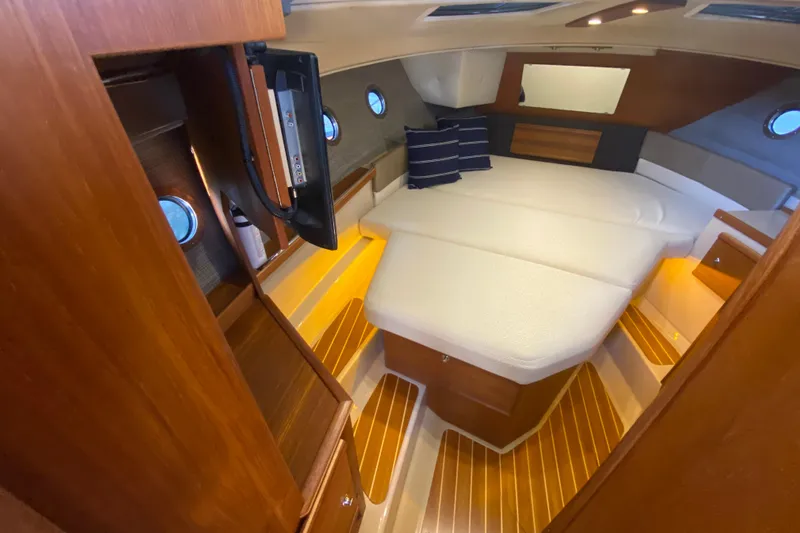  Yacht Photos Pics 2019 Ranger Tugs R-29 S cabin interior with cozy bed and wooden accents.