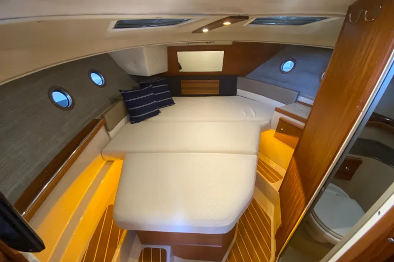  Yacht Photos Pics 2019 Ranger Tugs R-29 S cabin interior with cozy bed and ambient lighting.