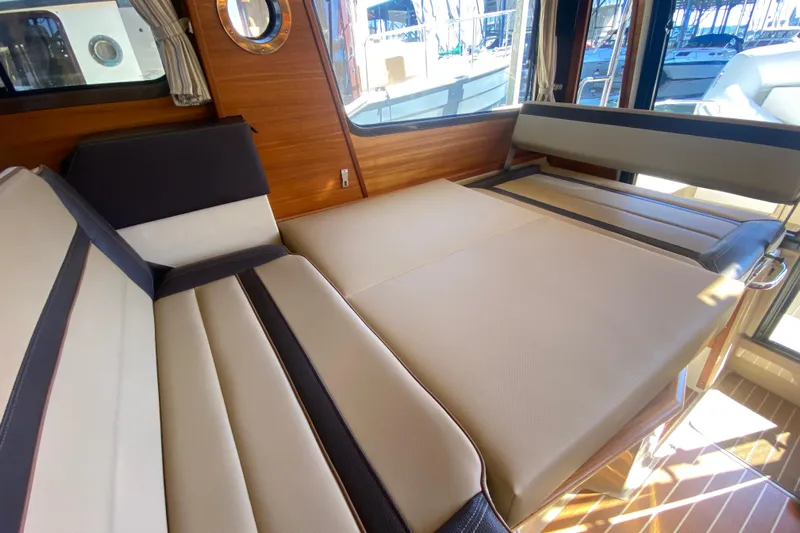  Yacht Photos Pics 2019 Ranger Tugs R-29 S interior with convertible seating and wood accents.