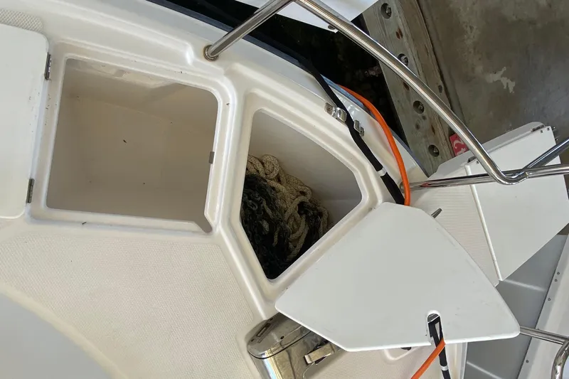  Yacht Photos Pics Open storage compartment on 2019 Ranger Tugs R-29 S boat, showing ropes inside.
