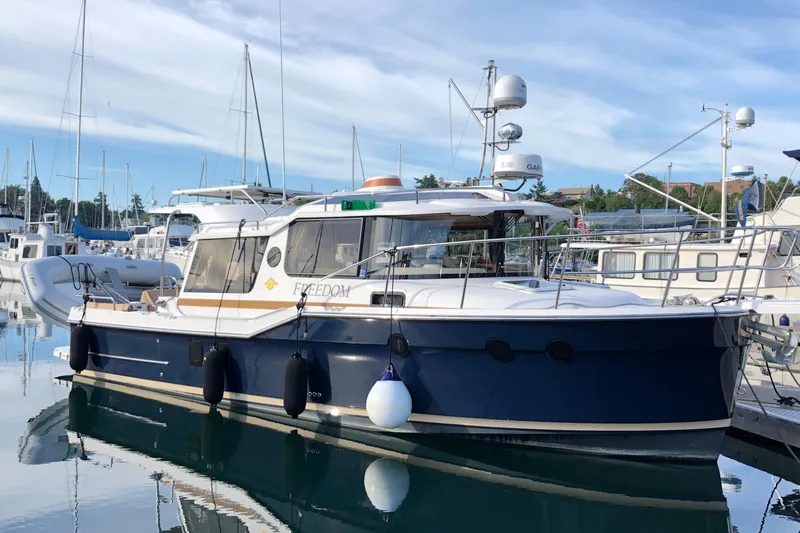  Yacht Photos Pics 2019 Ranger Tugs R-29 S boat docked in a marina, surrounded by other vessels.