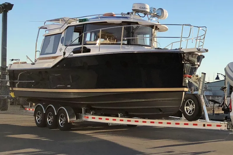  Yacht Photos Pics 2019 Ranger Tugs R-29 S boat on a trailer at a marina.