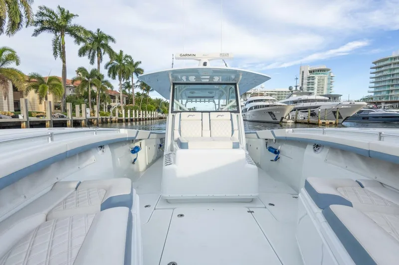 Rule #1 Yacht Photos Pics 2023 Yellowfin 42 Offshore boat docked, featuring spacious seating and modern design.