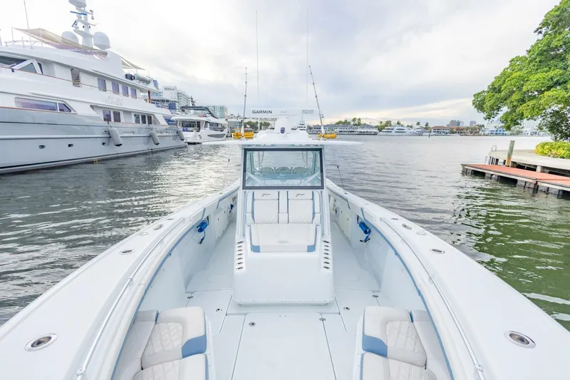 Rule #1 Yacht Photos Pics 2023 Yellowfin 42 Offshore boat docked, showcasing spacious deck and luxurious seating.