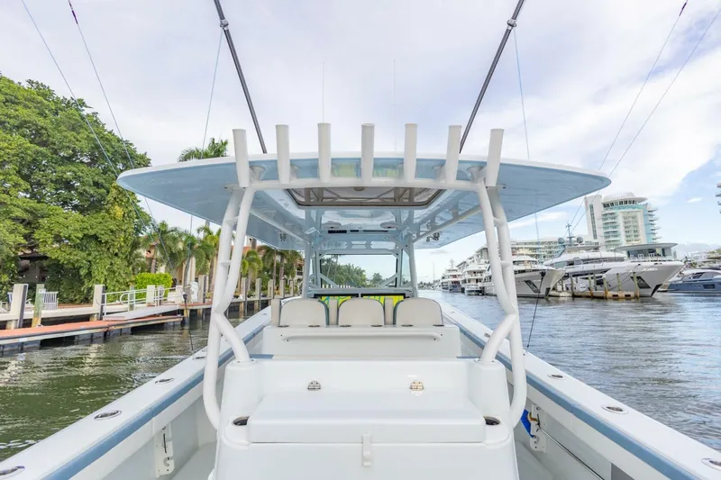 Rule #1 Yacht Photos Pics 2023 Yellowfin 42 Offshore boat docked in a marina, showcasing spacious deck and seating.