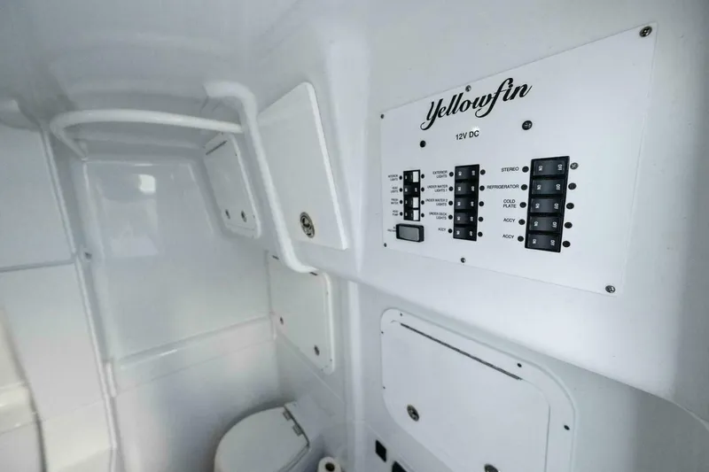 Rule #1 Yacht Photos Pics Interior of 2023 Yellowfin 42 Offshore boat with control panel and toilet.