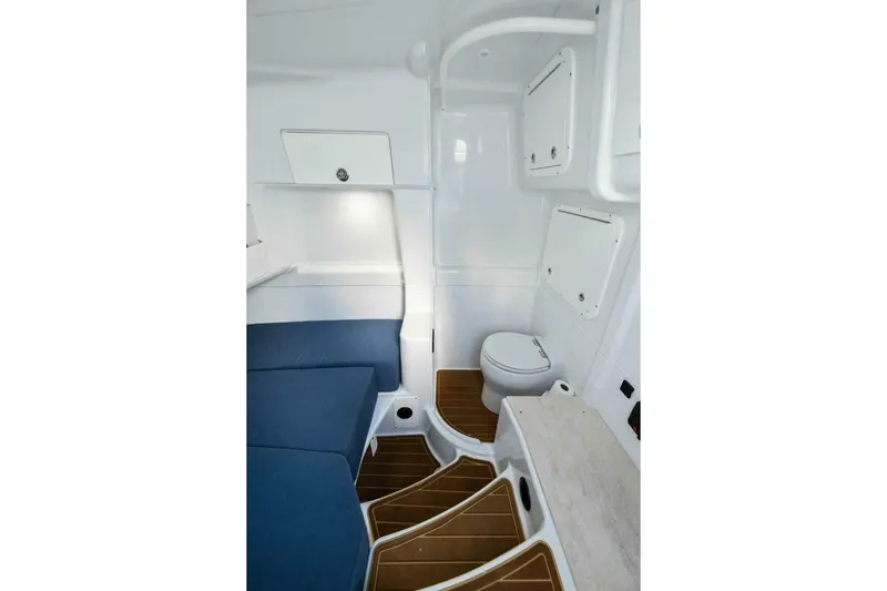Rule #1 Yacht Photos Pics 2023 Yellowfin 42 Offshore cabin interior with seating and marine toilet.