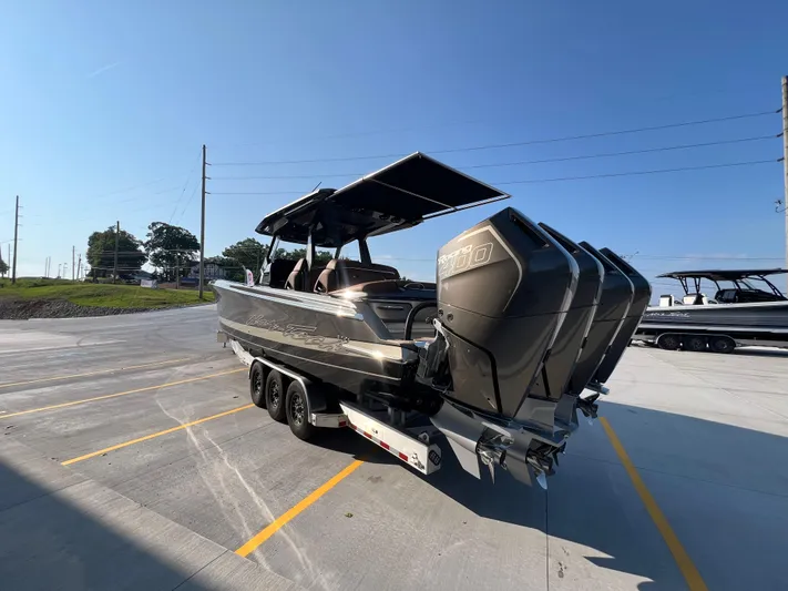  Yacht Photos Pics 2026 Nor-Tech 400 Supersport boat with powerful engines on a trailer in a parking lot.