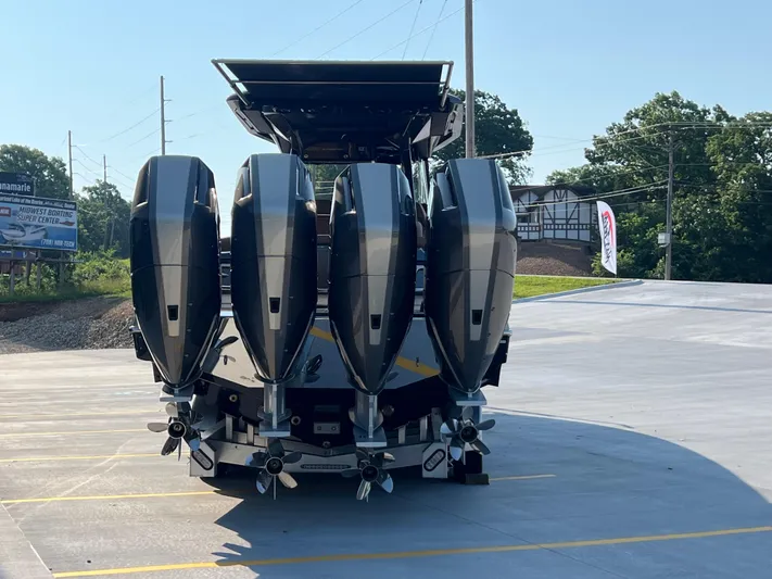  Yacht Photos Pics 2026 Nor-Tech 400 Supersport with four powerful outboard engines, parked outdoors.