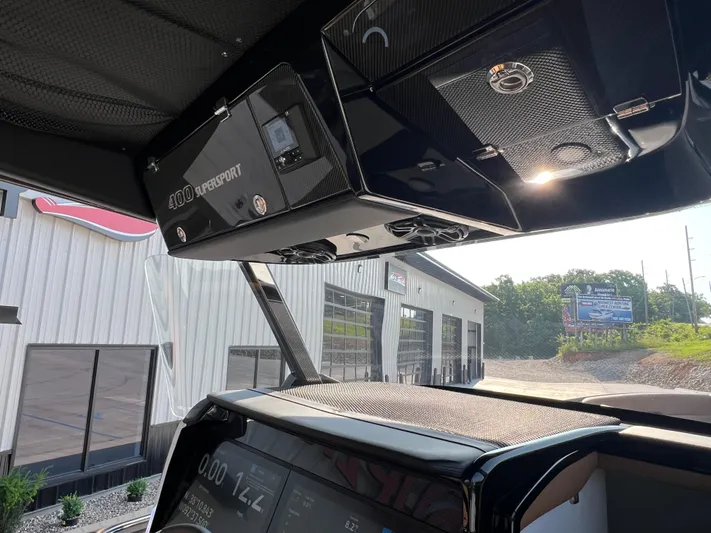  Yacht Photos Pics Interior view of 2026 Nor-Tech 400 Supersport boat, showcasing dashboard and overhead compartments.