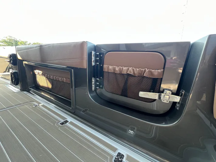  Yacht Photos Pics 2026 Nor-Tech 400 Supersport boat interior storage compartments with brown accents and secure latch.