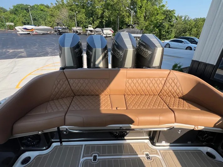  Yacht Photos Pics Luxurious seating on 2026 Nor-Tech 400 Supersport boat with quad engines, docked outdoors.