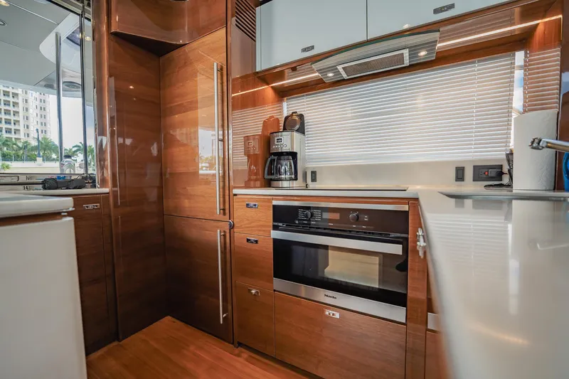 Endeavor Yacht Photos Pics Luxurious 2019 Princess F55 yacht kitchen with modern appliances and sleek wood finishes.