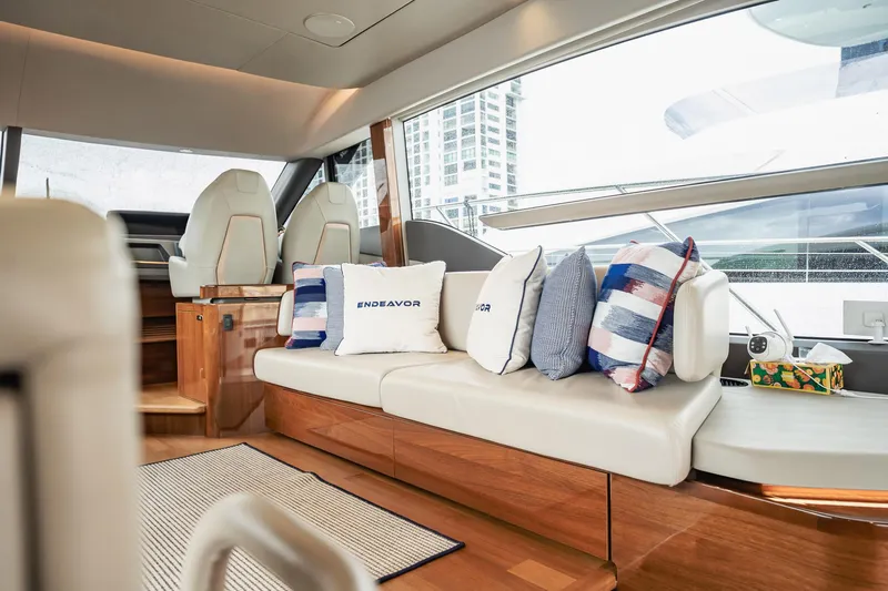 Endeavor Yacht Photos Pics Luxurious interior of 2019 Princess F55 yacht with plush seating and decorative pillows.