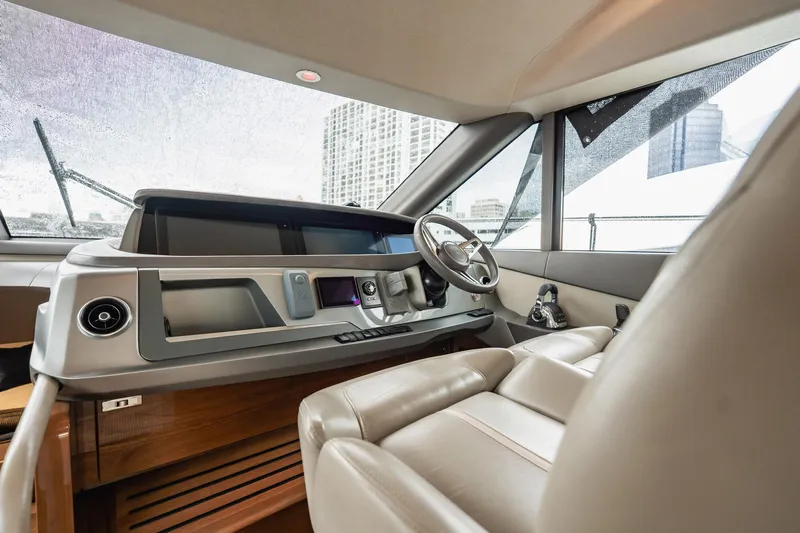 Endeavor Yacht Photos Pics Luxurious 2019 Princess F55 yacht helm with modern controls and leather seating.
