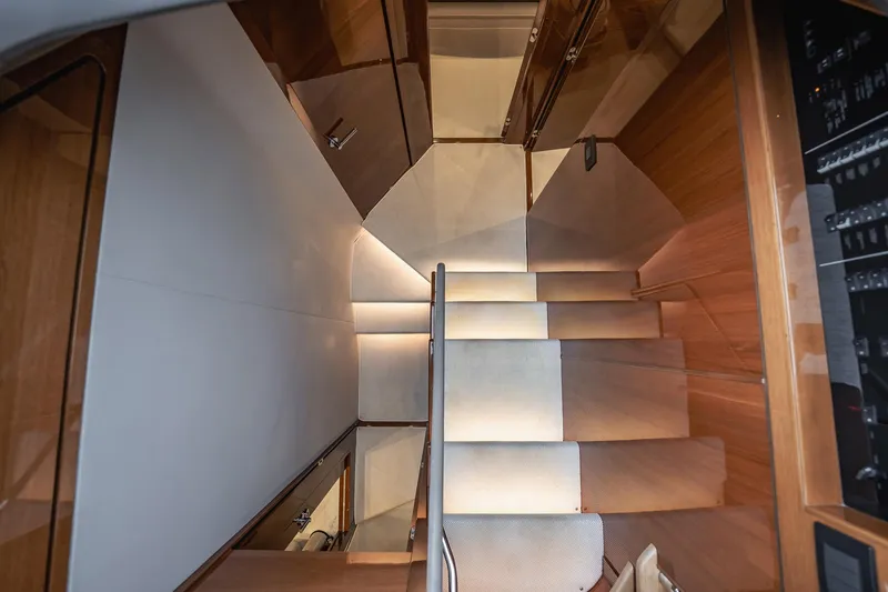 Endeavor Yacht Photos Pics Luxurious interior staircase of 2019 Princess F55 yacht with wooden finish.