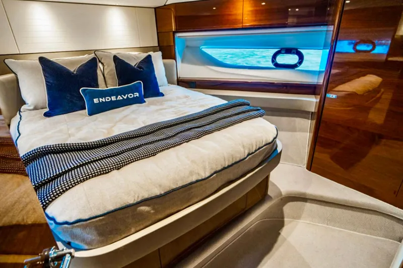 Endeavor Yacht Photos Pics Luxurious cabin interior of 2019 Princess F55 yacht with elegant bedding and ocean view.