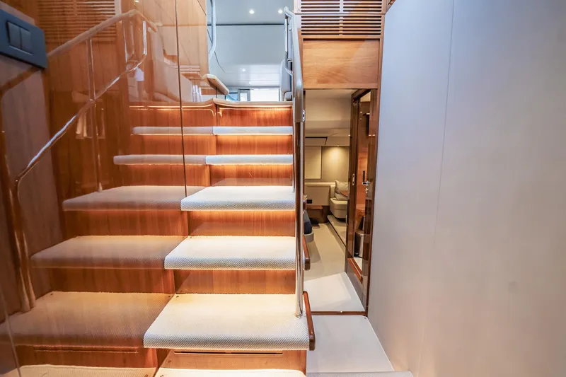 Endeavor Yacht Photos Pics Luxurious interior staircase of 2019 Princess F55 yacht with elegant wood finish.