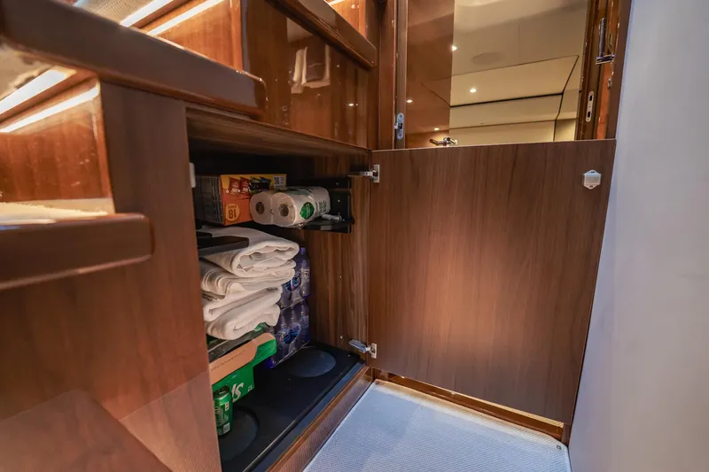 Endeavor Yacht Photos Pics Storage cabinet in 2019 Princess F55 yacht, stocked with towels, water, and supplies.