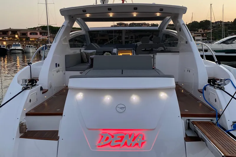 Dena Yacht Photos Pics 2021 Airon Cinquanta 50 yacht docked at sunset, featuring spacious deck and modern design.