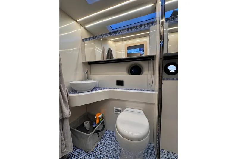 Dena Yacht Photos Pics Modern bathroom in 2021 Airon Cinquanta 50 yacht with sleek fixtures and mosaic tile flooring.