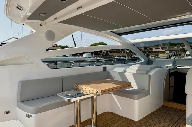 Dena Yacht Photos Pics Luxurious interior of 2021 Airon Cinquanta 50 yacht with sleek seating and wooden table.