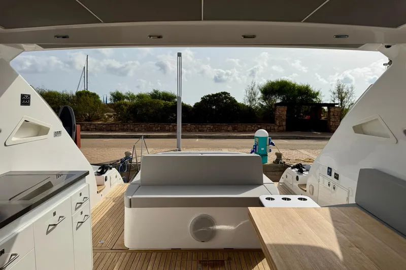 Dena Yacht Photos Pics Modern Airon Cinquanta 50 yacht interior, featuring sleek design and outdoor seating, 2021 model.