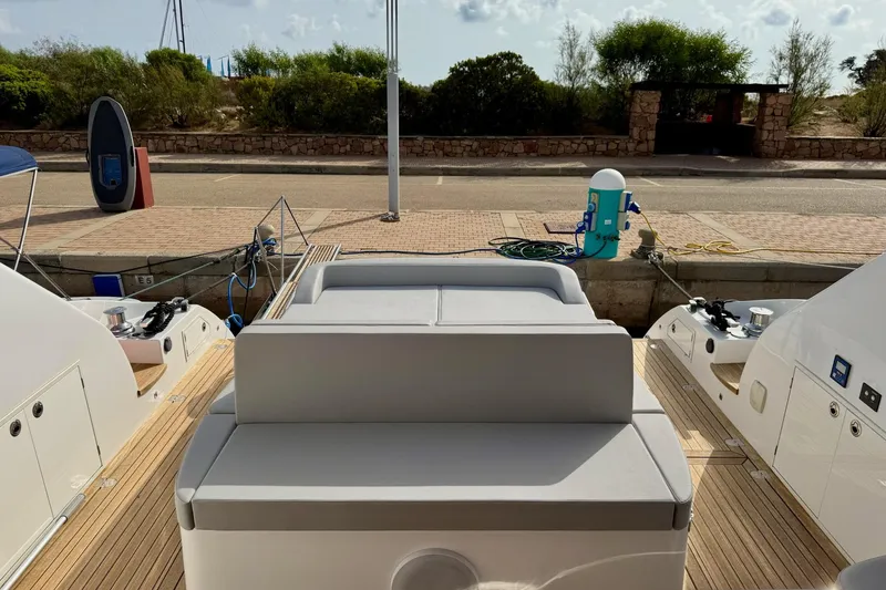 Dena Yacht Photos Pics Airon Cinquanta 50 yacht, 2021 model, docked with a view of the deck and marina.