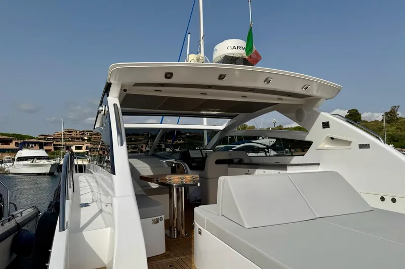 Dena Yacht Photos Pics 2021 Airon Cinquanta 50 yacht docked, featuring sleek design and spacious deck area.