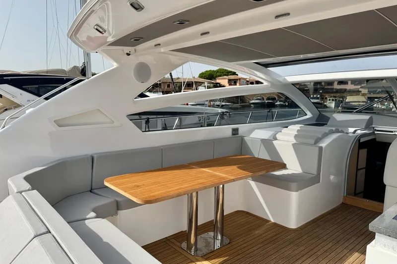Dena Yacht Photos Pics Luxurious 2021 Airon Cinquanta 50 yacht interior with elegant seating and wooden table.